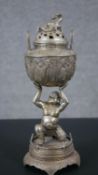 A Tibetan silver plated lidded Lohan and dragon design incense burner. H.32 W.12cm