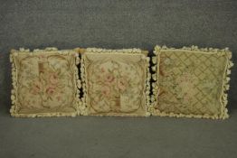 A pair of Aubusson type square cushions, depicting pink roses, with tassels around the edge,