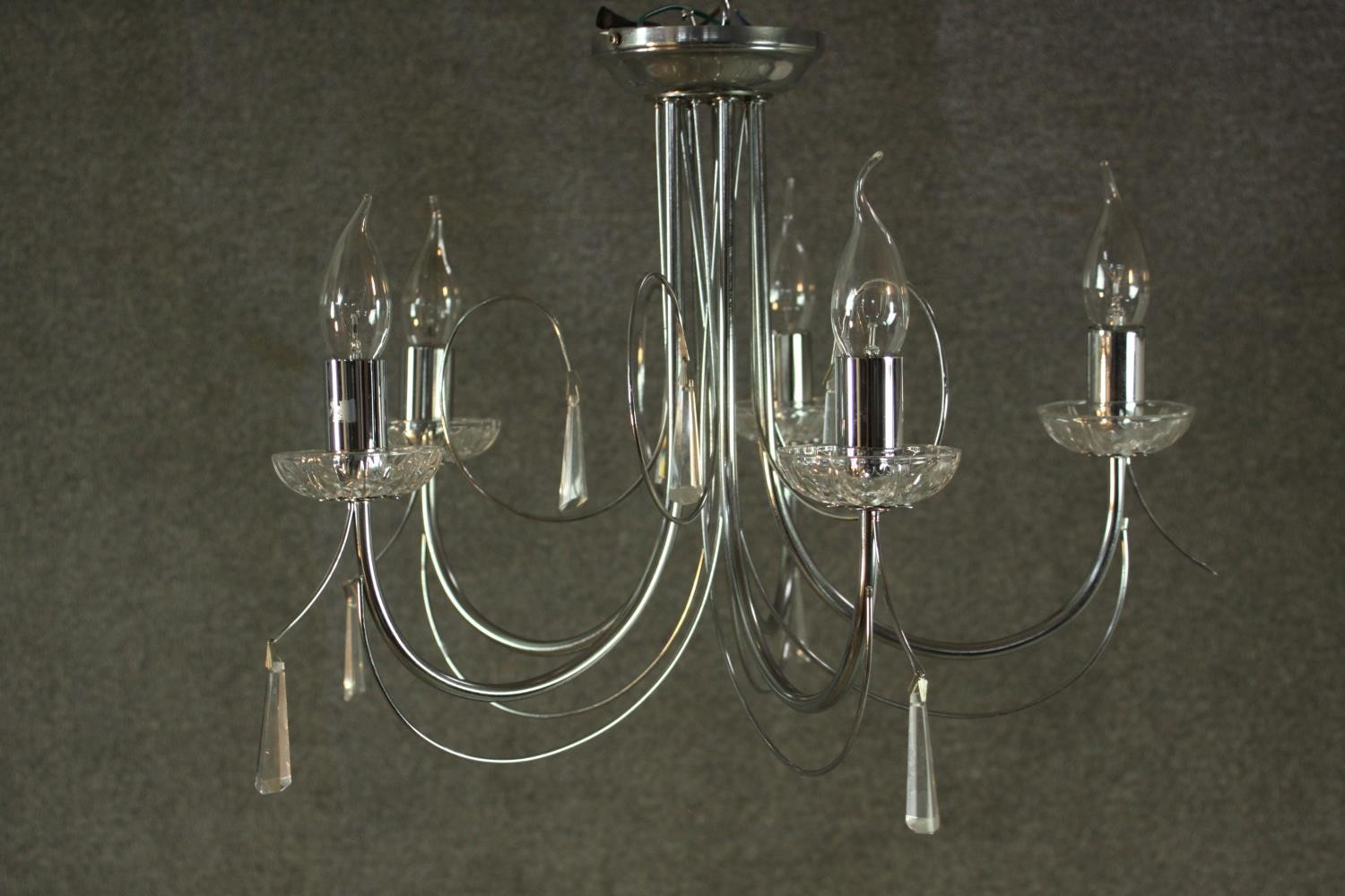 A contemporary chrome chandelier, with five curved branches and glass drip trays. H.37 W.43cm. - Image 2 of 4