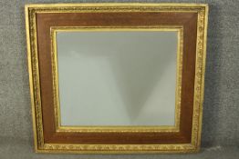 A 19th century oak and parcel gilt framed mirror, with a plain mirror plate, the frame with two