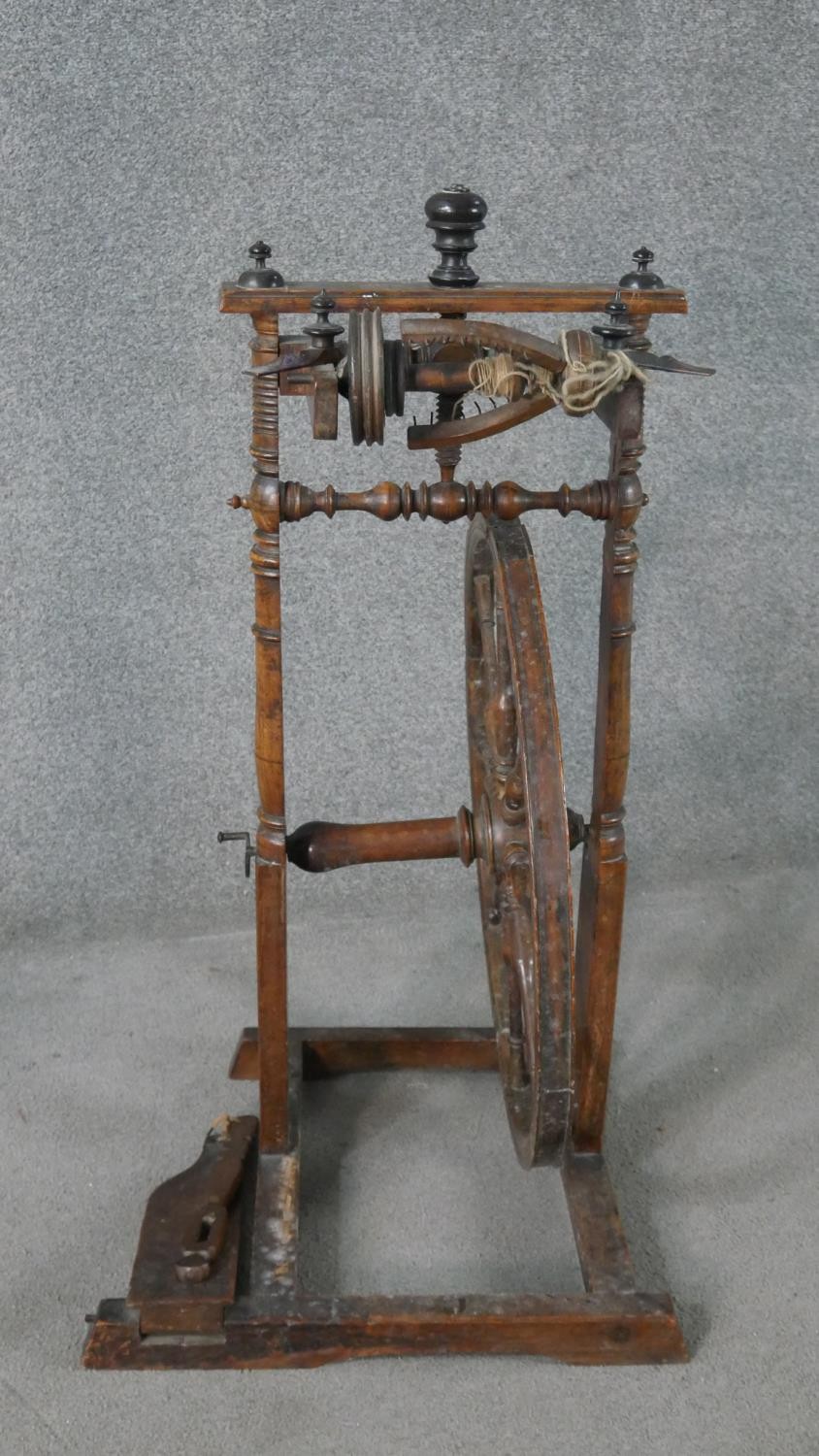 A 19th century spinning wheel in turned beech along with a wool spinners stand. H.178cm (largest) - Image 4 of 11