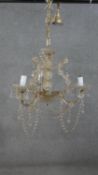 A large cut crystal and cane glass three branch chandelier with hanging crystal drops and swags. H.