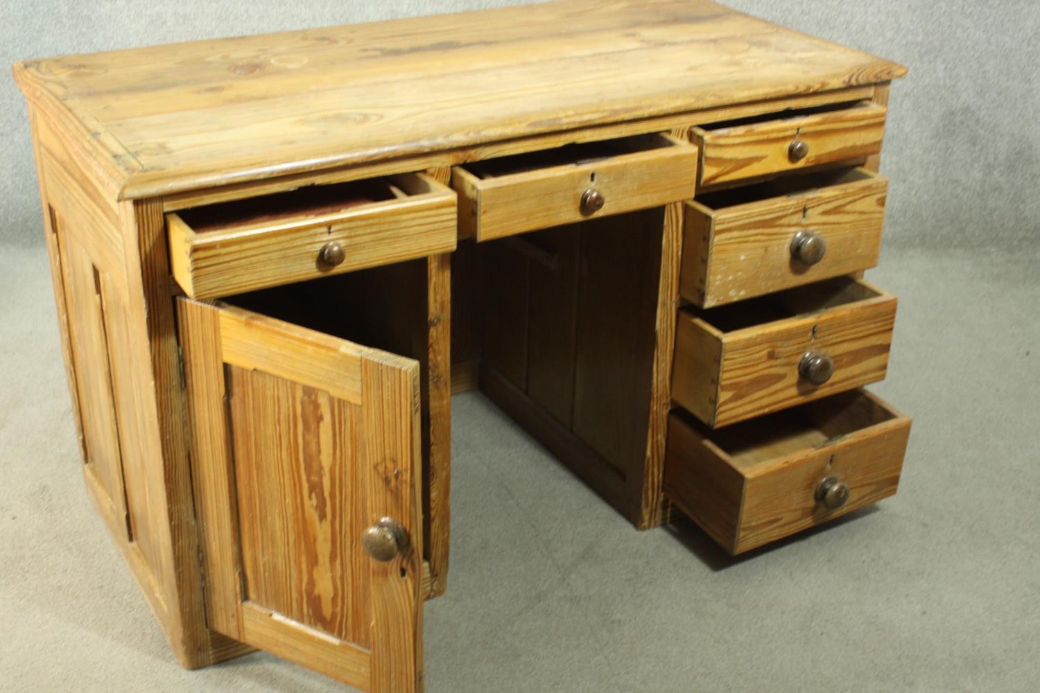 A Victorian pitch pine kneehole desk, with three short drawers, over a cupboard door to one - Image 6 of 8