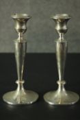 A pair of silver candlesticks, marked Walker and Hall Sheffield, 1924. H.22cm.