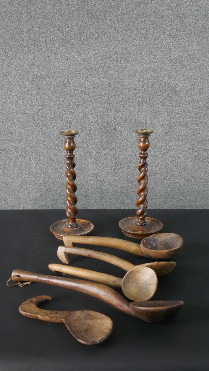 A pair of vintage oak barleytwist candlesticks along with a collection of five carved rustic - Image 2 of 8