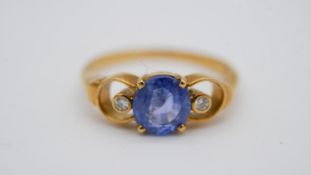 An 18 carat yellow gold Ceylon sapphire and diamond dress ring, set to centre with an oval mixed cut