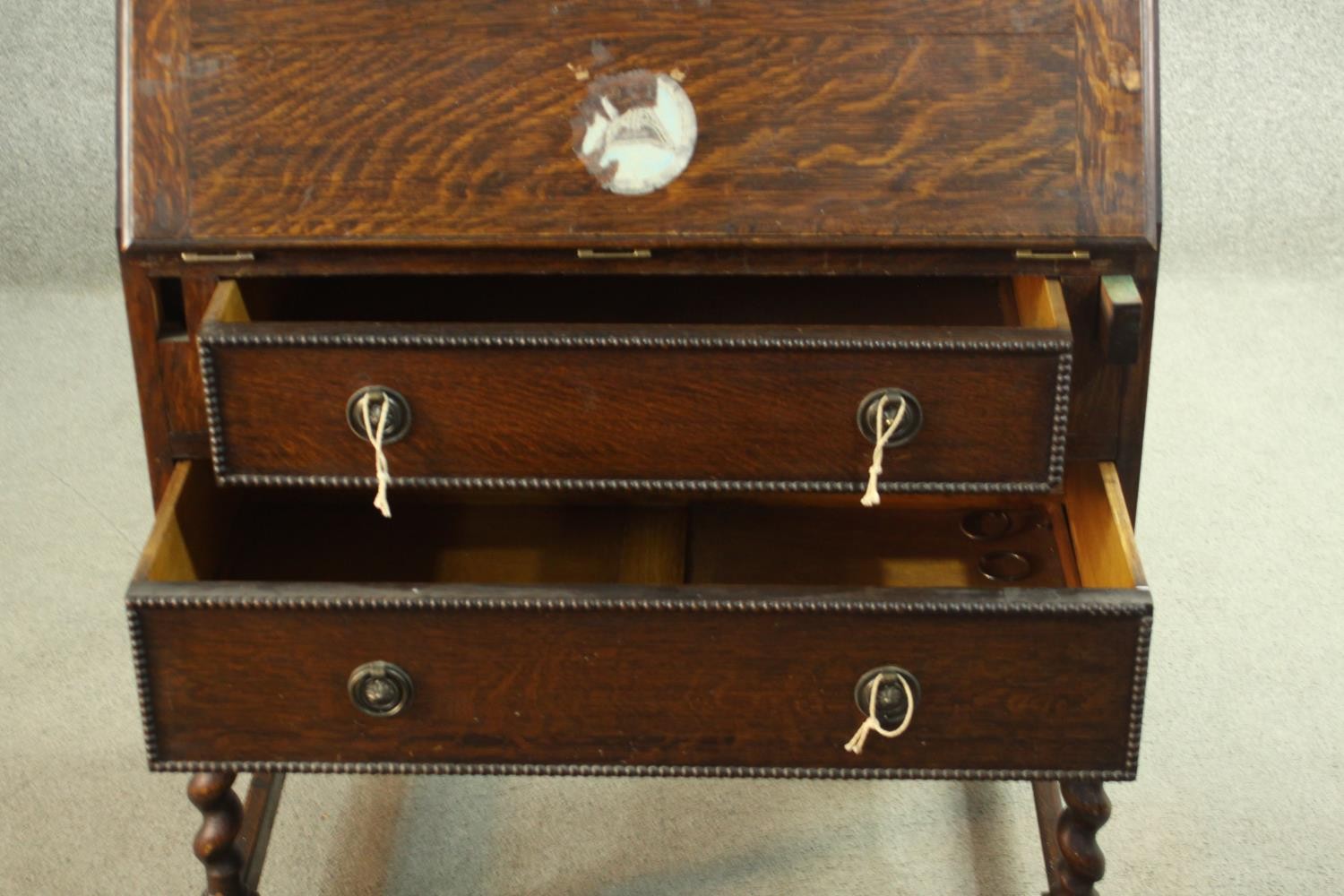 An early 20th century oak bureau, the fall front opening to reveal a fitted interior consisting of - Image 5 of 8