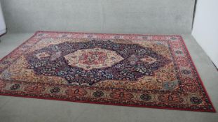 A Louis de Poortere woollen Kashan motif carpet, on a deep blue ground. L.300 W.205cm