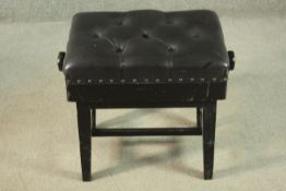 A late Victorian adjustable piano stool, with a buttoned black leather seat, on ebonised square