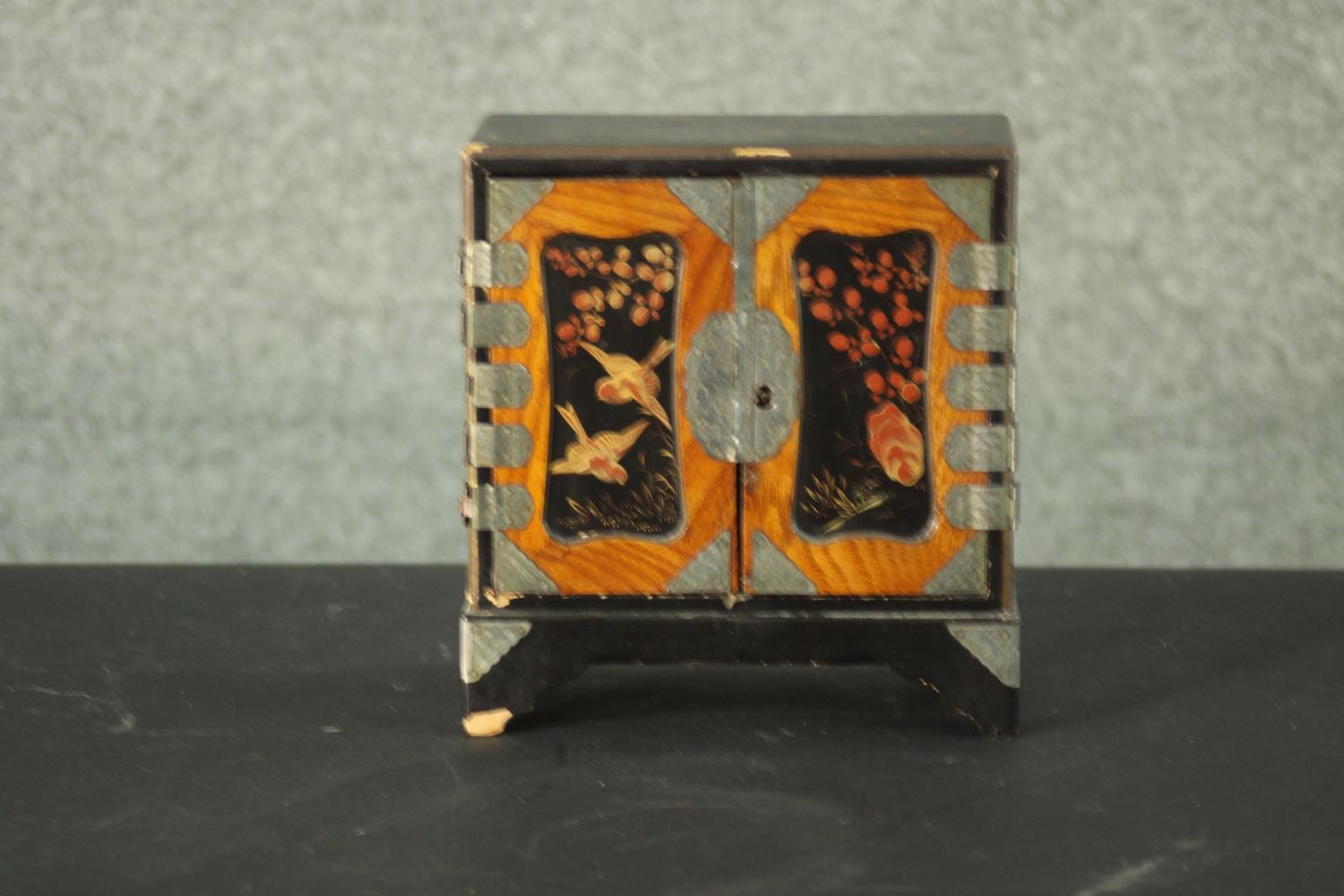 A small Japanese lacquer jewellery cabinet decorated with flowers and birds. (left door does not