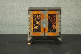 A small Japanese lacquer jewellery cabinet decorated with flowers and birds. (left door does not