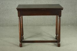 WITHDRAWN - An early 20th century oak foldover card table, of rectangular form, the top with a green