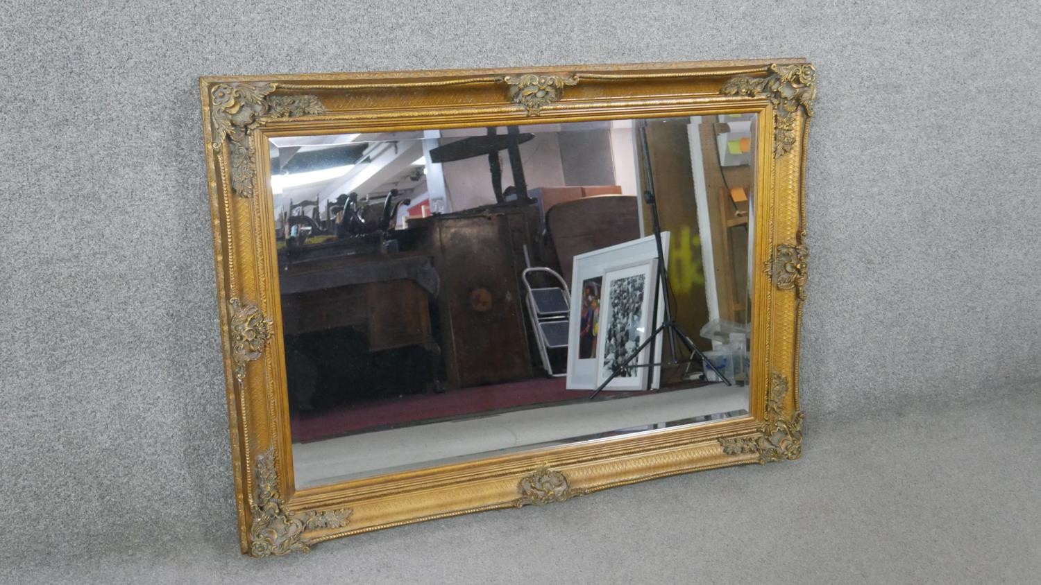 A rectangular gilt framed wall mirror, with a bevelled mirror plate, the frame with moulded