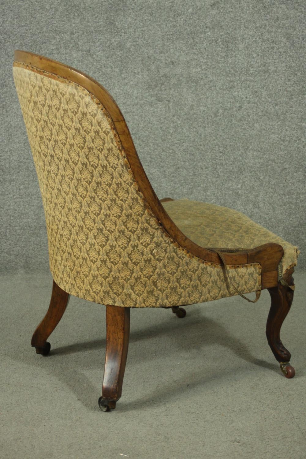 A Victorian walnut nursing chair, upholstered in green fabric, on carved cabriole legs. - Image 3 of 5