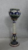 A Victorian Doulton Lambeth stoneware jardiniere on stand with flowerhead blue glaze decoration. H.