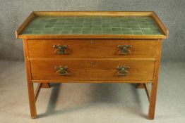 A pine washstand, with a three quarter gallery back over a green tiled top, above two long drawers