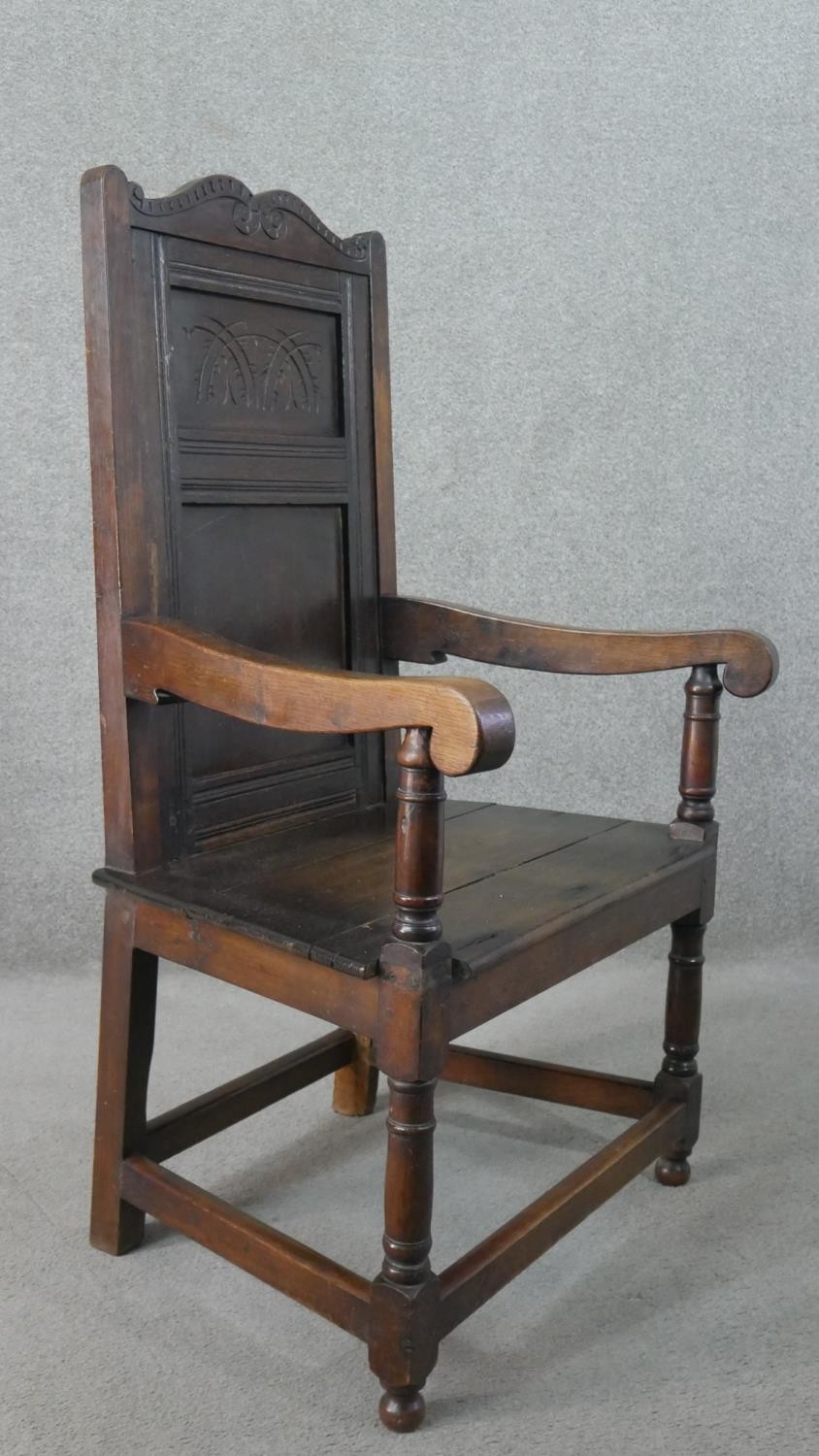 A late 19th century oak wainscot armchair, the panelled back with scrolling top rail, over open - Image 2 of 6