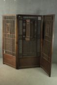An early 20th century Ottoman Syrian hardwood screen, of three folds, decorated with an intricate