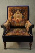 A late Victorian armchair, upholstered in blue velour, with sections of a Persian Sarouk rug to