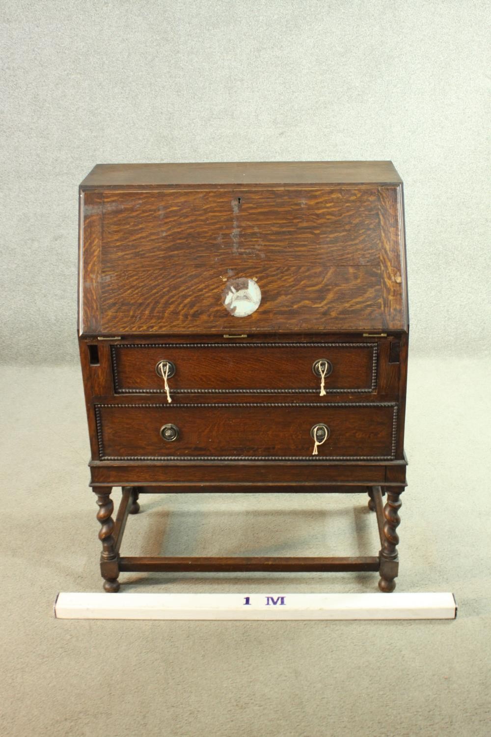 An early 20th century oak bureau, the fall front opening to reveal a fitted interior consisting of - Image 2 of 8