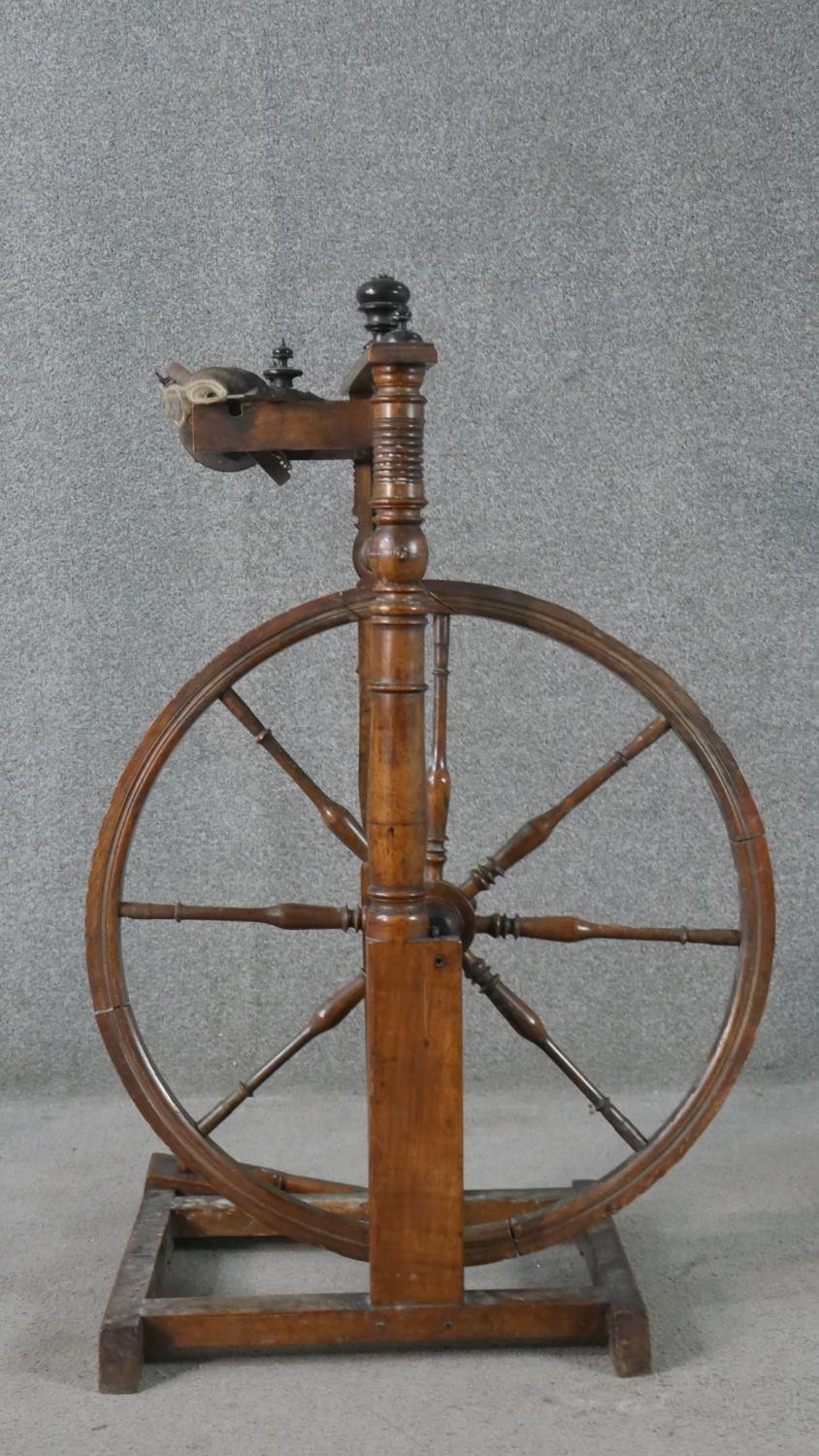 A 19th century spinning wheel in turned beech along with a wool spinners stand. H.178cm (largest) - Image 7 of 11