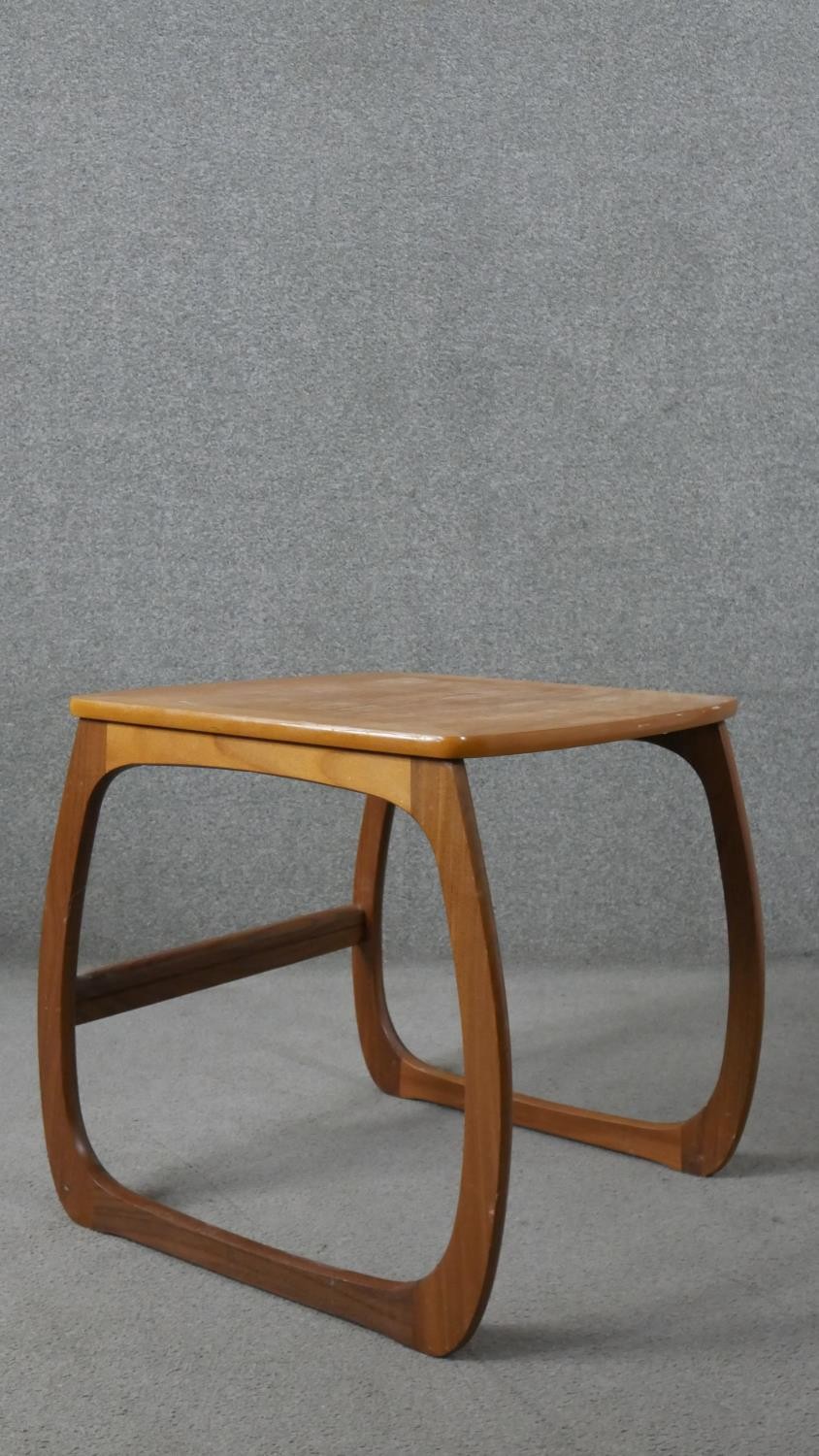 A nest of three Nathan teak tables, with crossbanded tops, on curved legs, with paper label to the - Image 6 of 6