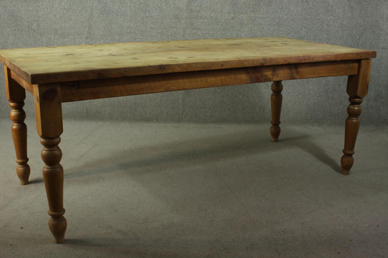 A pine refectory farmhouse dining table, with a rectangular top, on turned legs. - Image 6 of 7