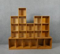 Eight mid 20th century oak Unix shelving units, of cubed storage sections, including two plinth