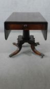 A Regency style mahogany drop leaf dining table, the end drawer with a turned handle, over a