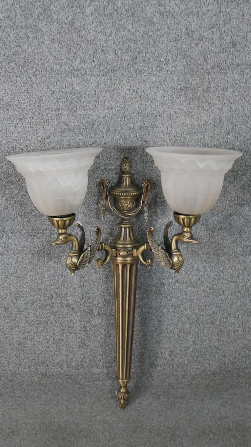 A two branch classical design brass swan head and ribbon design wall light with alabaster glass