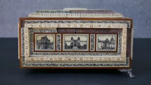 A bone and scrimshaw work vintage box with red silk lining, decorated with buildings and flower