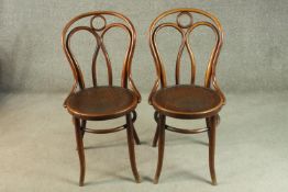 A pair of late 19th/early 20th century Thonet style bentwood chairs, with circular pokerwork seats.