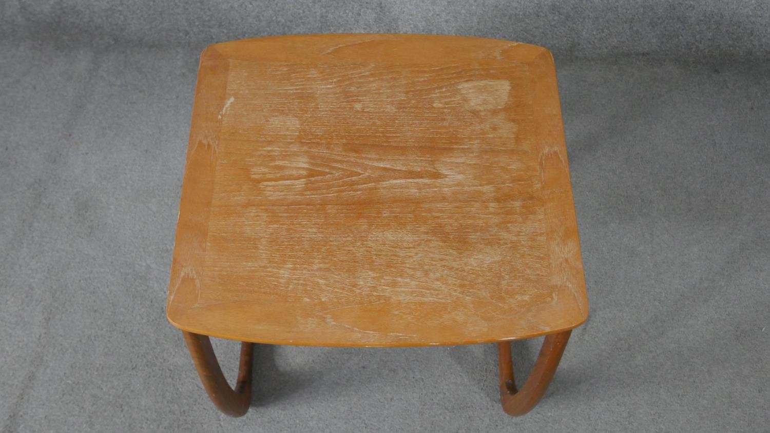 A nest of three Nathan teak tables, with crossbanded tops, on curved legs, with paper label to the - Image 5 of 6
