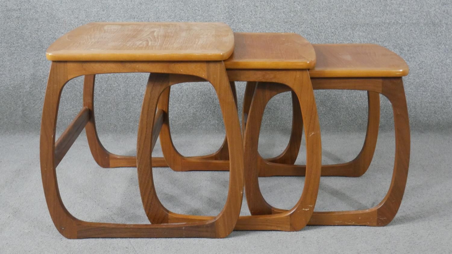 A nest of three Nathan teak tables, with crossbanded tops, on curved legs, with paper label to the - Image 3 of 6