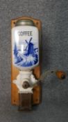 A vintage wall mounted coffee grinder, Dutch blue and white porcelain and with maker's mark. H.44