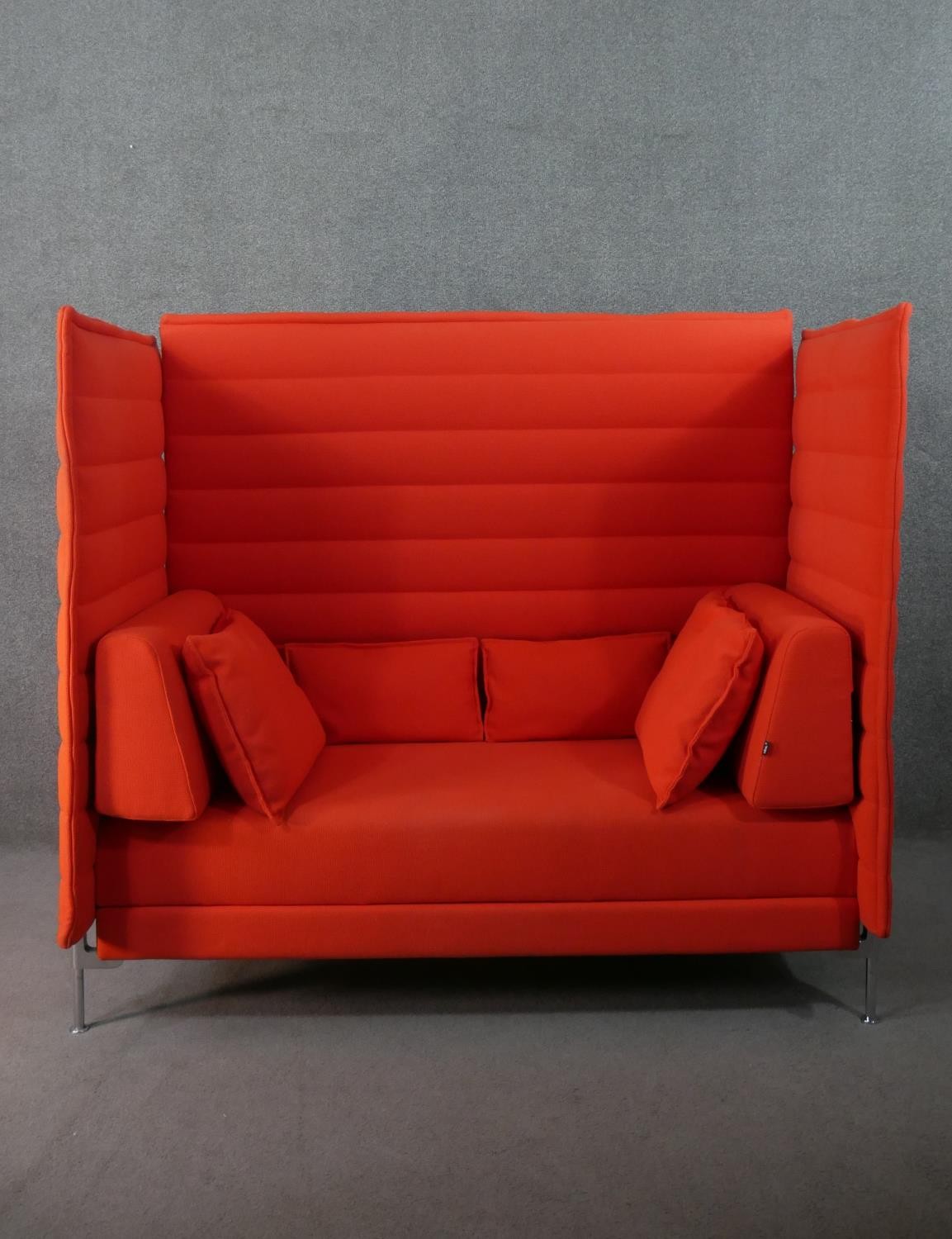 A contemporary Vitra Alcove High Back two seater sofa, upholstered in red fabric, with loose