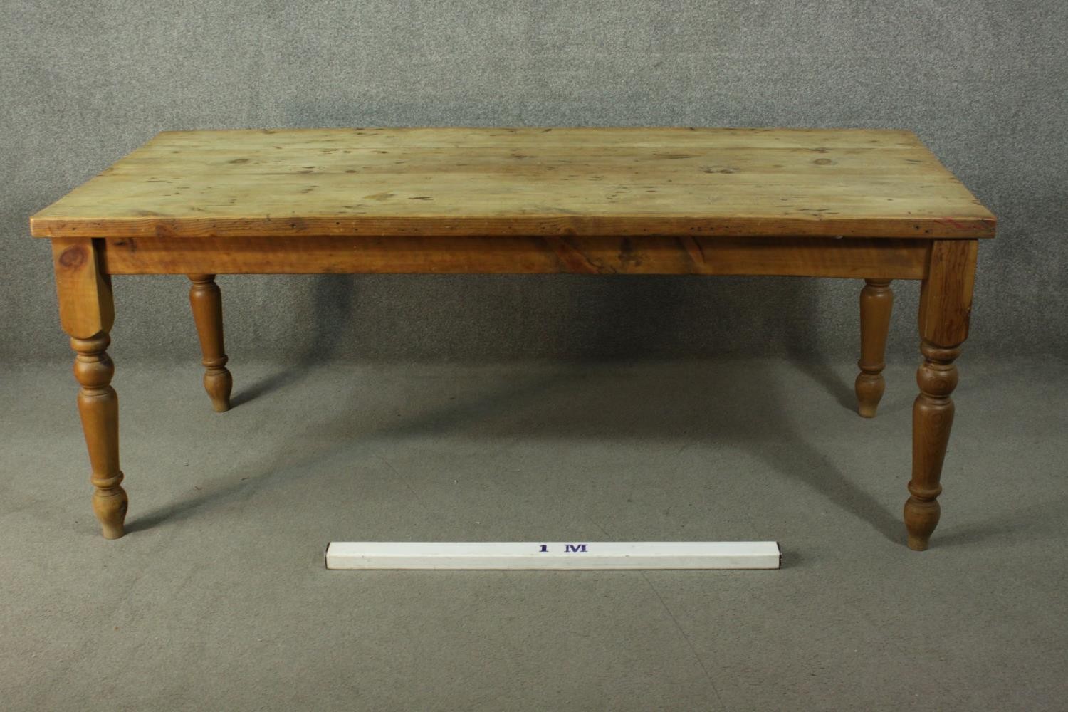 A pine refectory farmhouse dining table, with a rectangular top, on turned legs. - Image 2 of 7