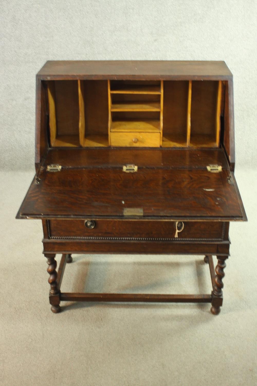 An early 20th century oak bureau, the fall front opening to reveal a fitted interior consisting of - Image 3 of 8