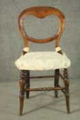 A Victorian walnut saddle back dining chair, on turned splayed legs, joined by bobbin turned