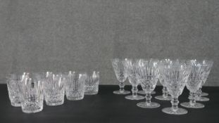 A set of ten cut glass whiskey tumblers and ten matching wine glasses. H.14 Diam.10cm (largest)