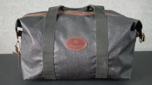 A Mulberry Scotchgrain leather holdall with zipped tartan interior and identification number. H.36