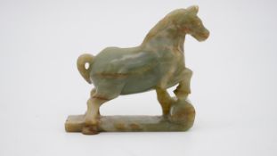 A Chinese carved Jade horse on scroll base. H.11 W.11 D.3cm