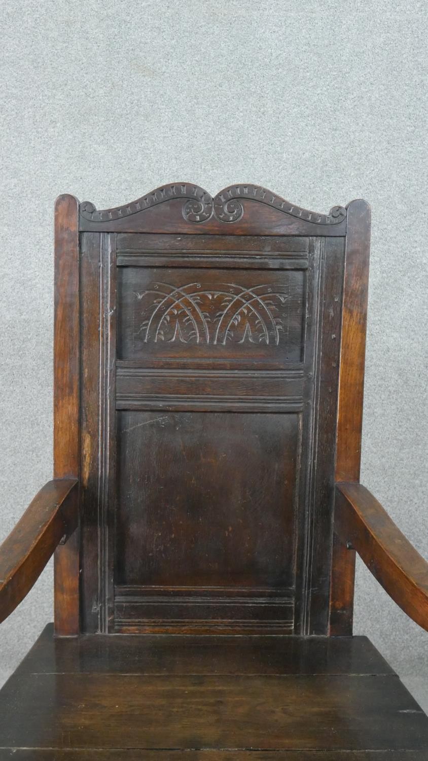 A late 19th century oak wainscot armchair, the panelled back with scrolling top rail, over open - Image 4 of 6