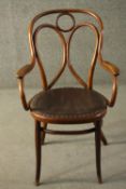 A late 19th/early 20th century Thonet style bentwood chair, with open arms, and a brown rexine seat.