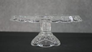 A cut crystal cake stand with stylised petal design. H.12 Diam.28cm