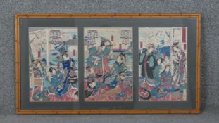 After Toyohara Kunichika, a framed and glazed Japanese woodblock print tryptich, Meigi Zoroi,