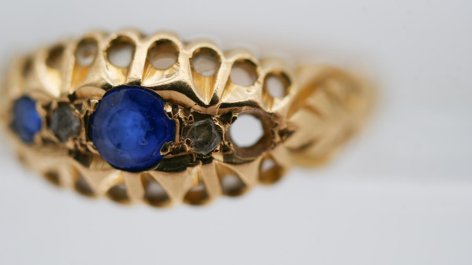 An 18 carat yellow gold sapphire and diamond gypsy ring, set with two round mixed cut sapphires - Image 6 of 10