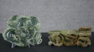A large Chinese carved jade figure of a leaping fish in the waves along with a carved green stone