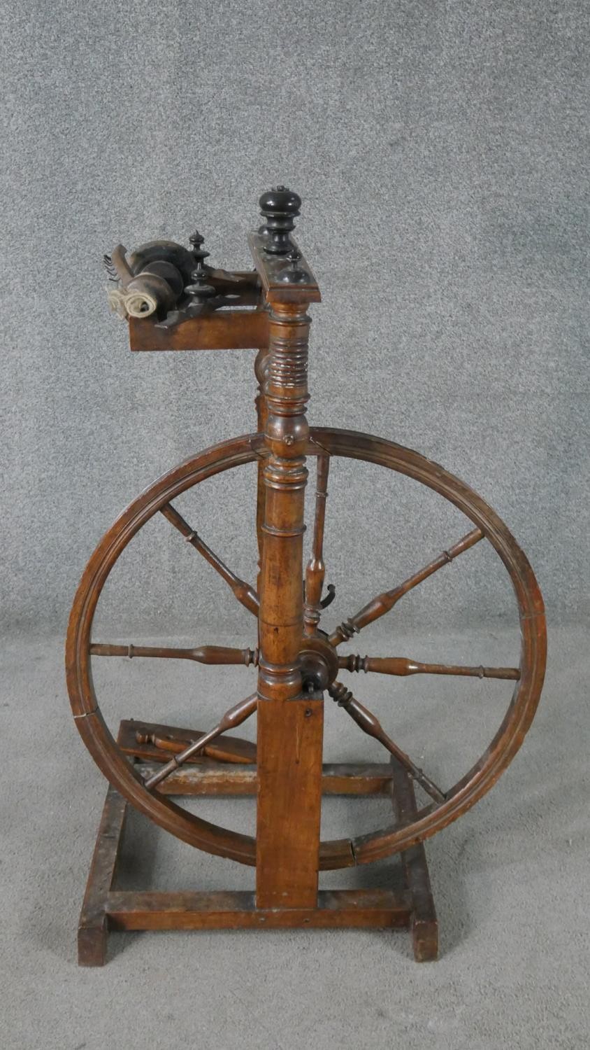 A 19th century spinning wheel in turned beech along with a wool spinners stand. H.178cm (largest) - Image 3 of 11