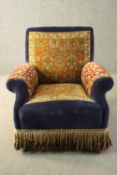 A late Victorian armchair, upholstered in blue velour, with sections of a Persian Sarouk rug to